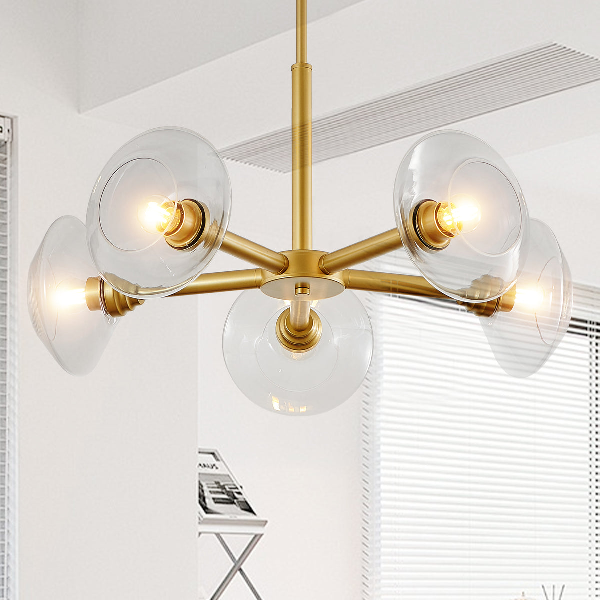 Gold iron Sputnik chandelier with five lights, stylish Atelier design by Anthony & Home, featuring a modern geometric fixture.