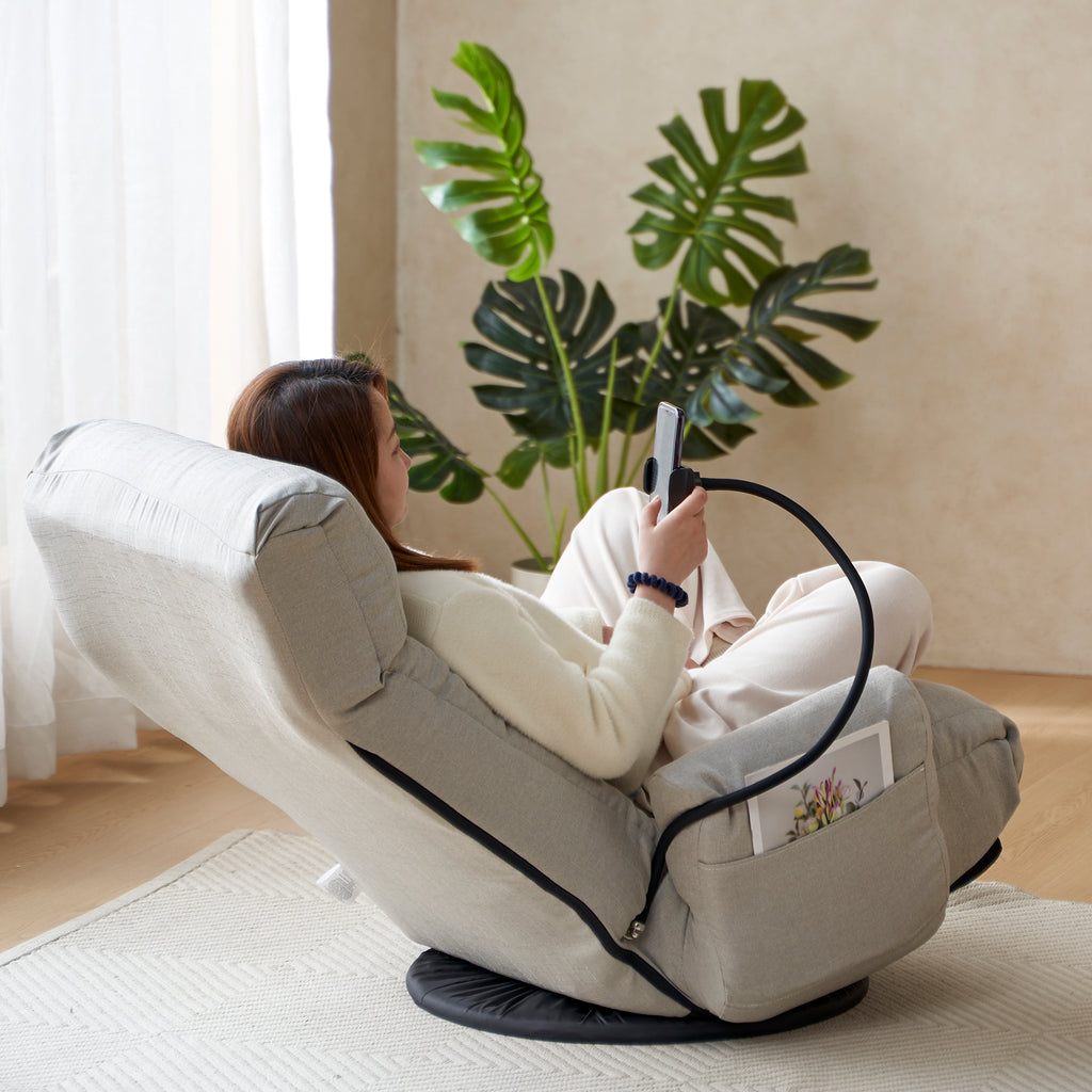 Gray swivel lounge chair by Anthony & Home with 360-degree rotation, featuring a modern design and cushioned seating.