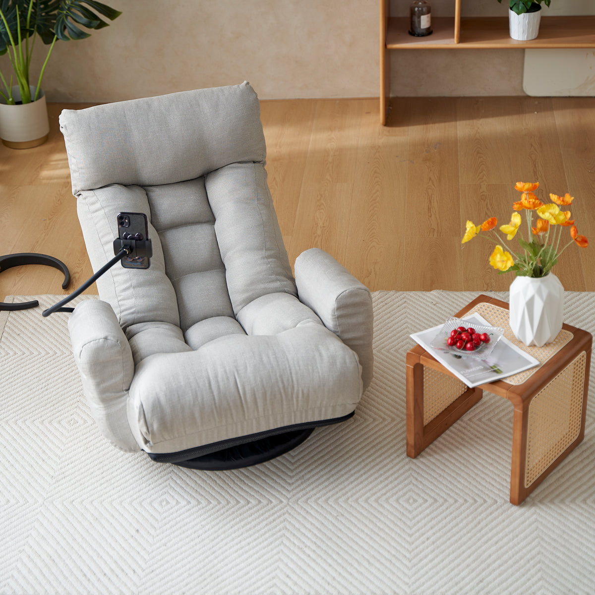 Gray swivel lounge chair by Anthony & Home with 360-degree rotation, featuring a modern, comfortable design for living spaces.