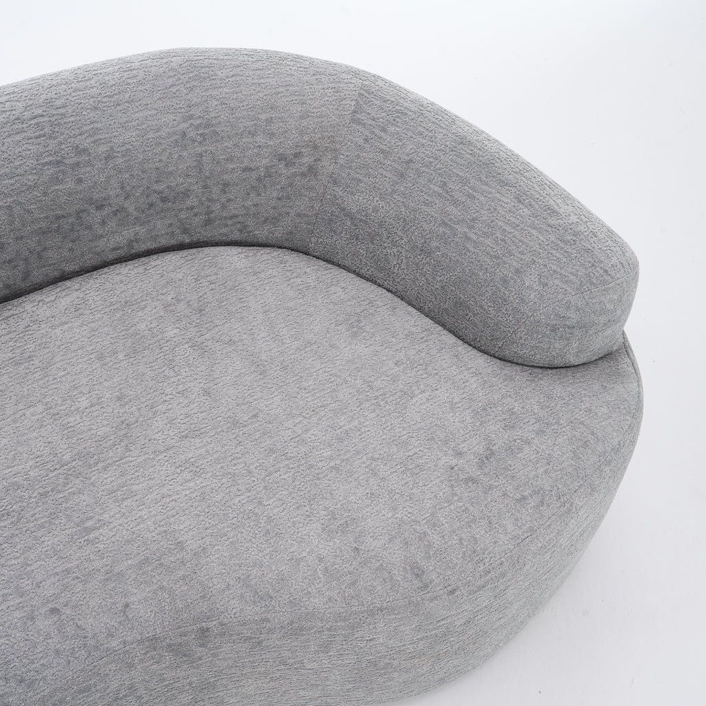 Grey curved modular sofa by Anthony & Home in soft chenille fabric, showcasing its luxurious, contemporary design.