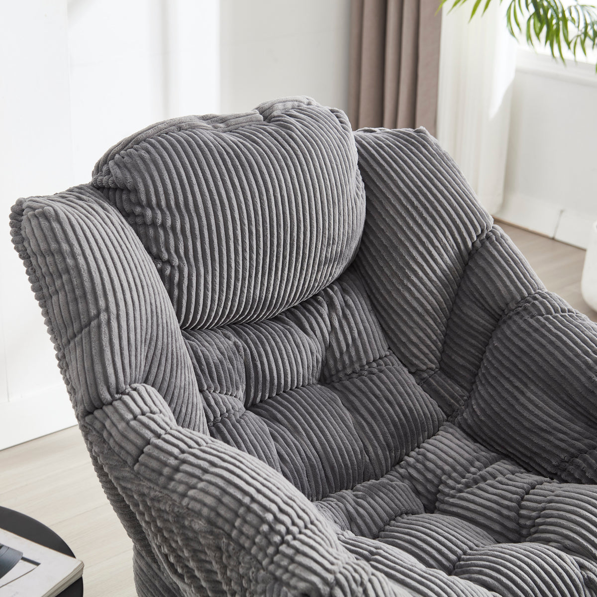 Grey upholstered lounge chair with matching ottoman, featuring armrests and modern design from Anthony & Home.