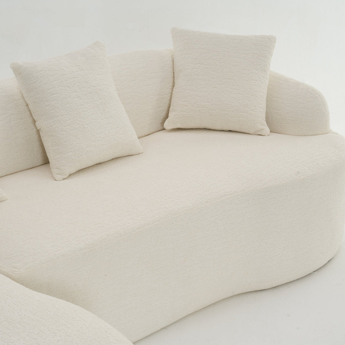 Anthony & Home Heritage Collection L-shaped sectional with curved chaise in elegant minimalist design, shown in a modern living room setting.