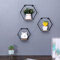 Set of three natural wood hexagonal floating shelves by Anthony & Home, wall-mounted for modern storage and display.