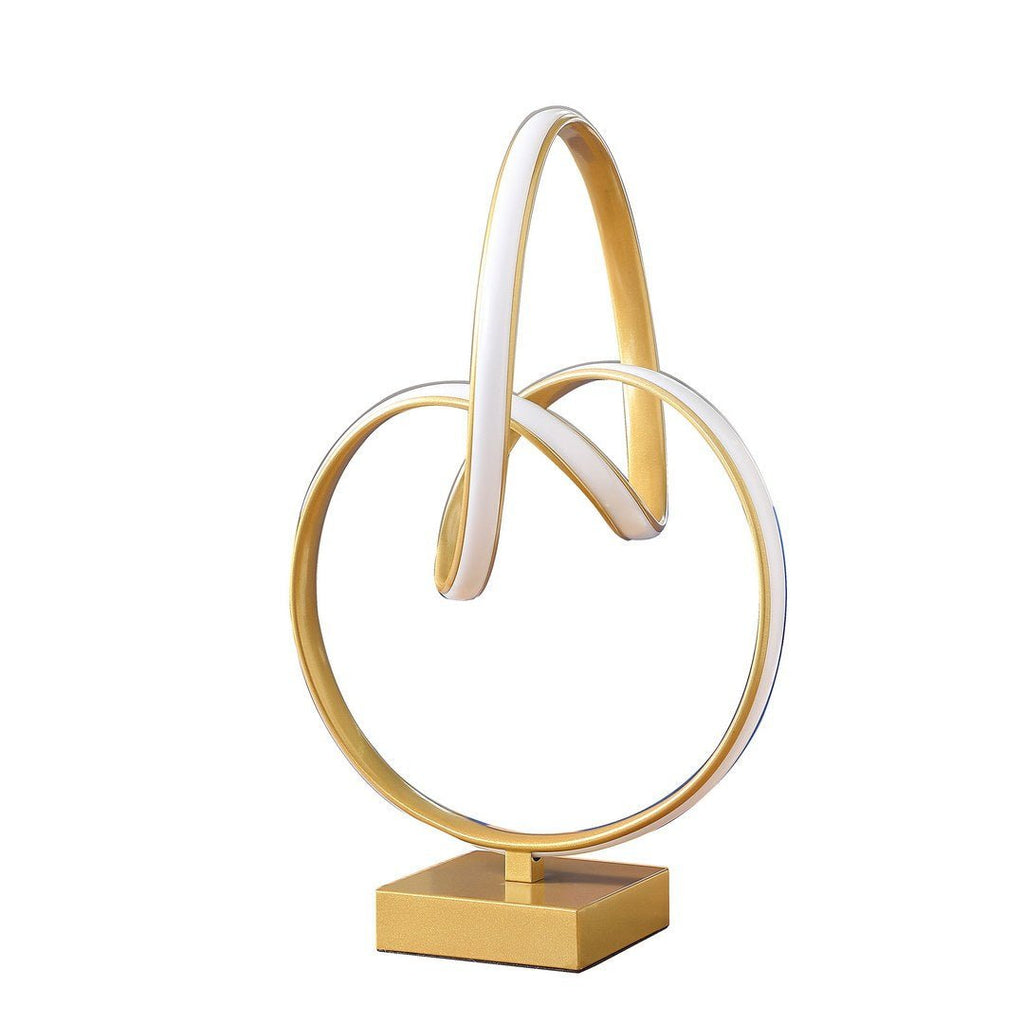 Infinity matte gold table lamp with LED lighting by Anthony & Home, modern design, shown on a sleek surface.