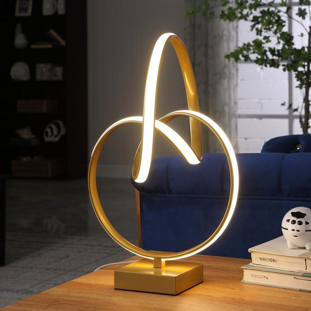 Infinity matte gold table lamp with LED Atelier by Anthony & Home, featuring a sleek modern design and warm lighting.