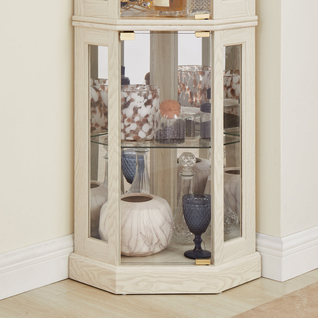 Lighted curio cabinet with curved silhouette by Anthony & Home, limited edition display case for collectibles and decorative items.