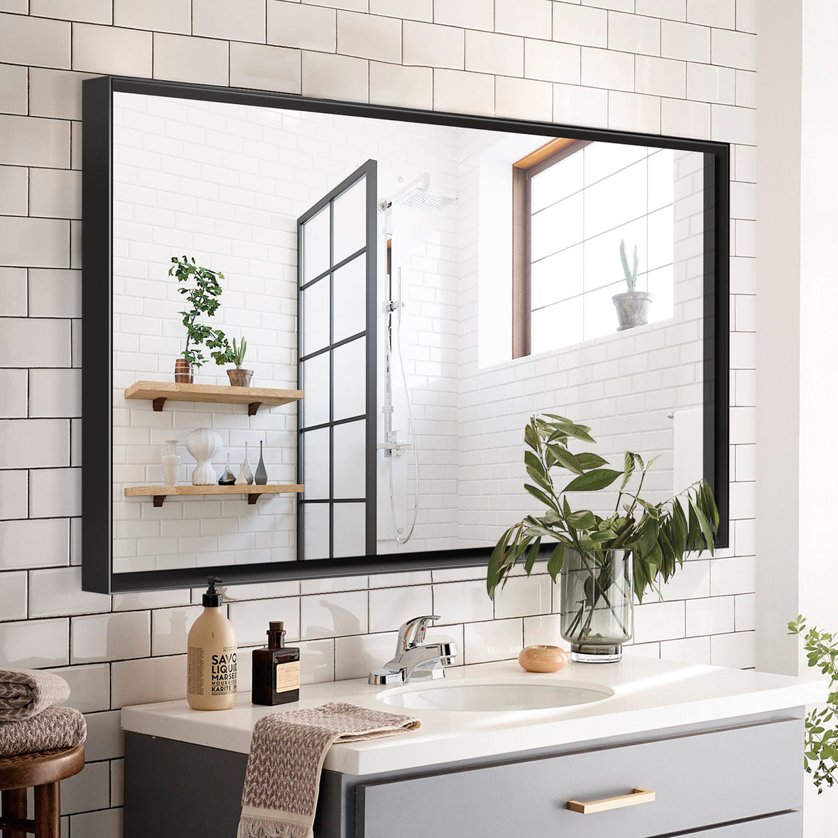 Black aluminum bathroom mirror with sleek rectangular design, featuring a modern finish and clean lines.
