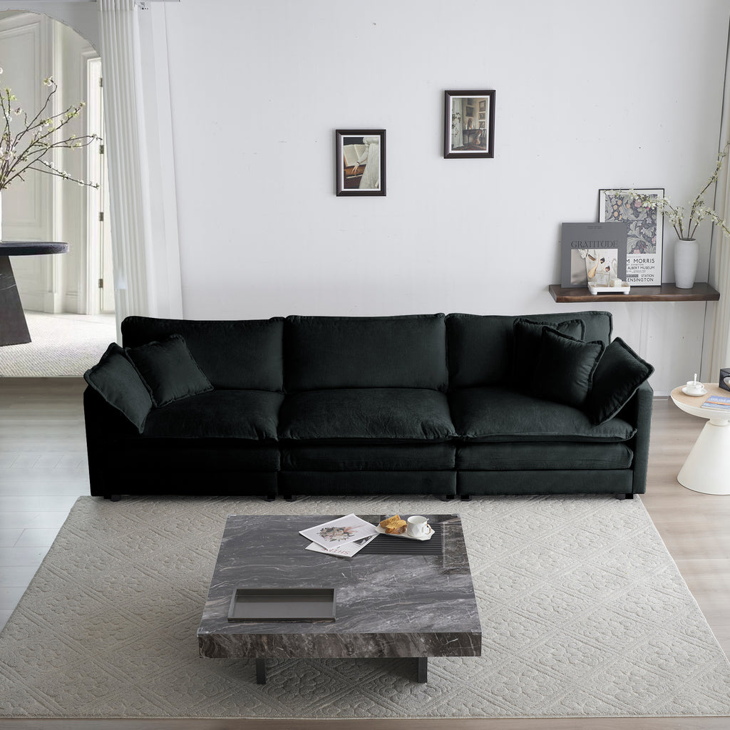 Black oversized chenille sectional sofa with modular L-shape and reversible ottoman by Anthony & Home.