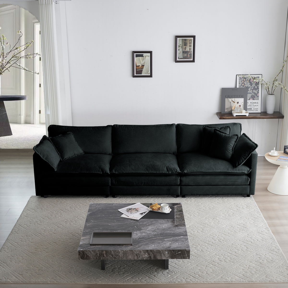 Black oversized chenille sectional sofa with modular L-shape and reversible ottoman by Anthony & Home.