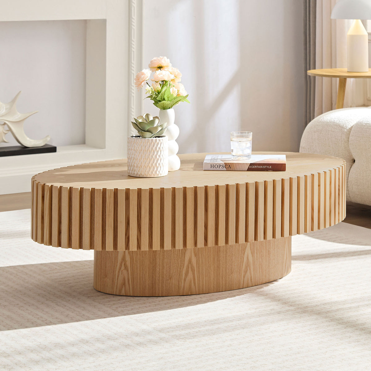 Natural ash drum coffee table with elliptical shape by Anthony & Home, showcasing a limited edition design in a modern living room.