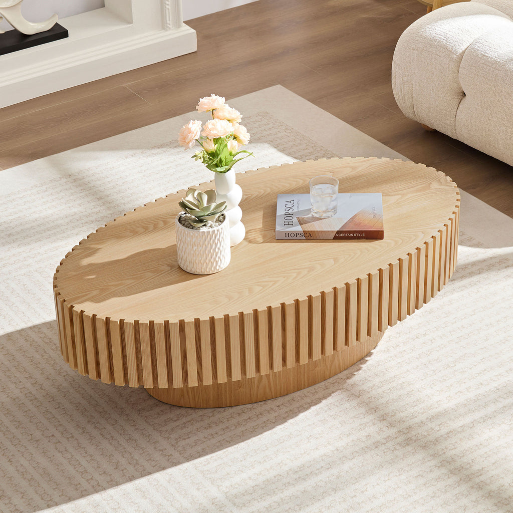 Natural ash drum coffee table with elliptical shape from Anthony & Home's limited edition collection, showcasing smooth wood grain and modern design.