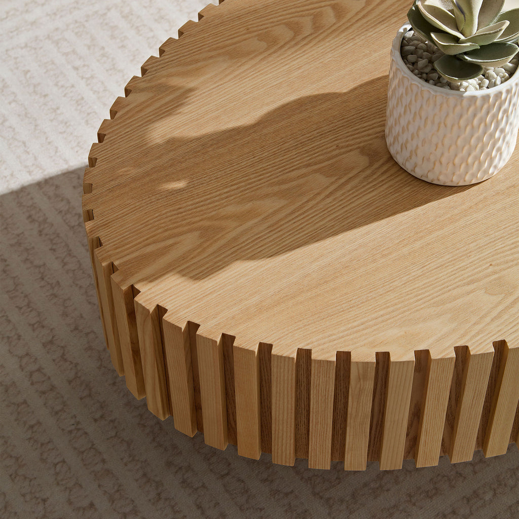 Natural ash drum coffee table in ellipse shape by Anthony & Home, showcasing smooth wood grain and modern design.