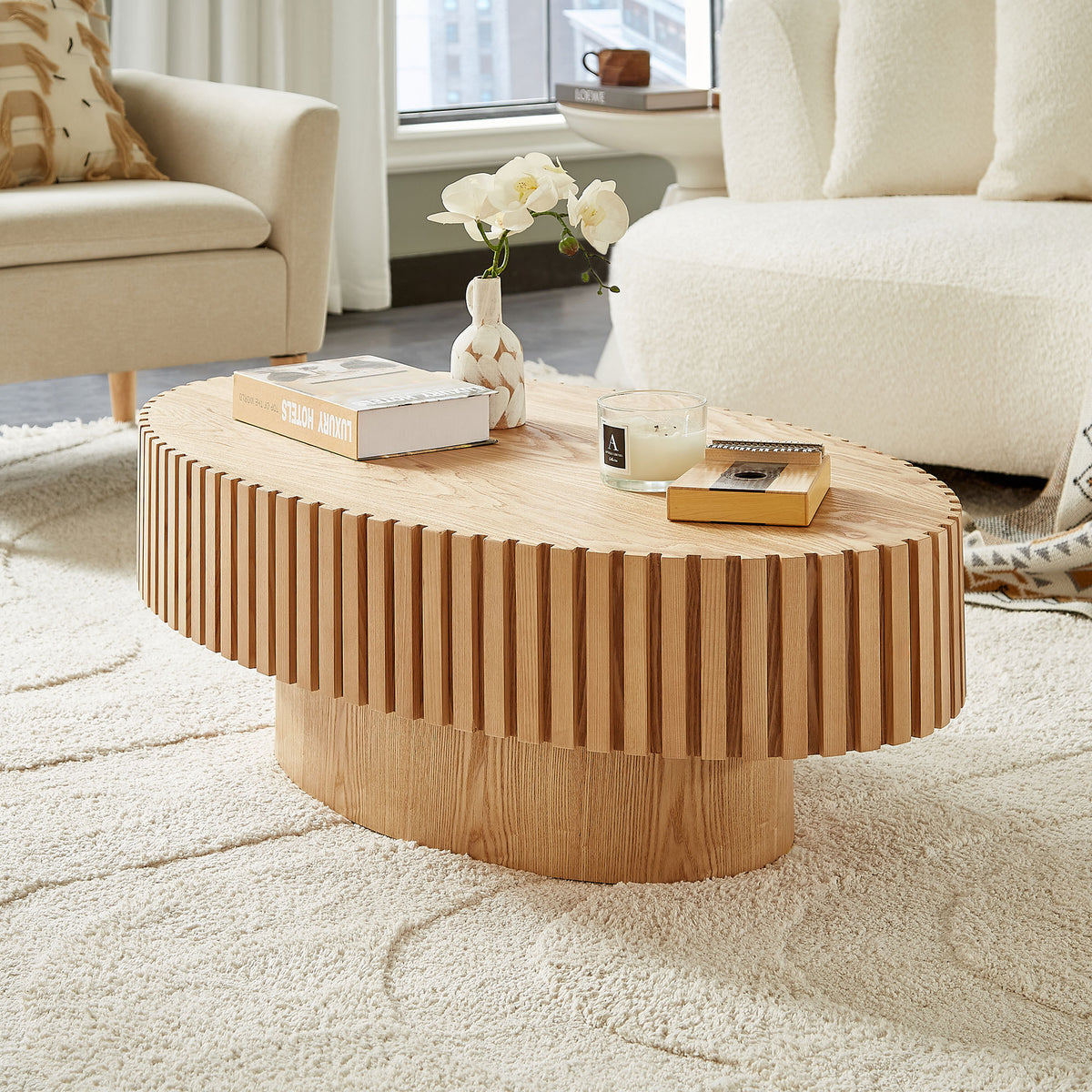 Natural ash drum coffee table with elliptical shape from Anthony & Home's limited edition collection, showcasing smooth wood grain and modern design.