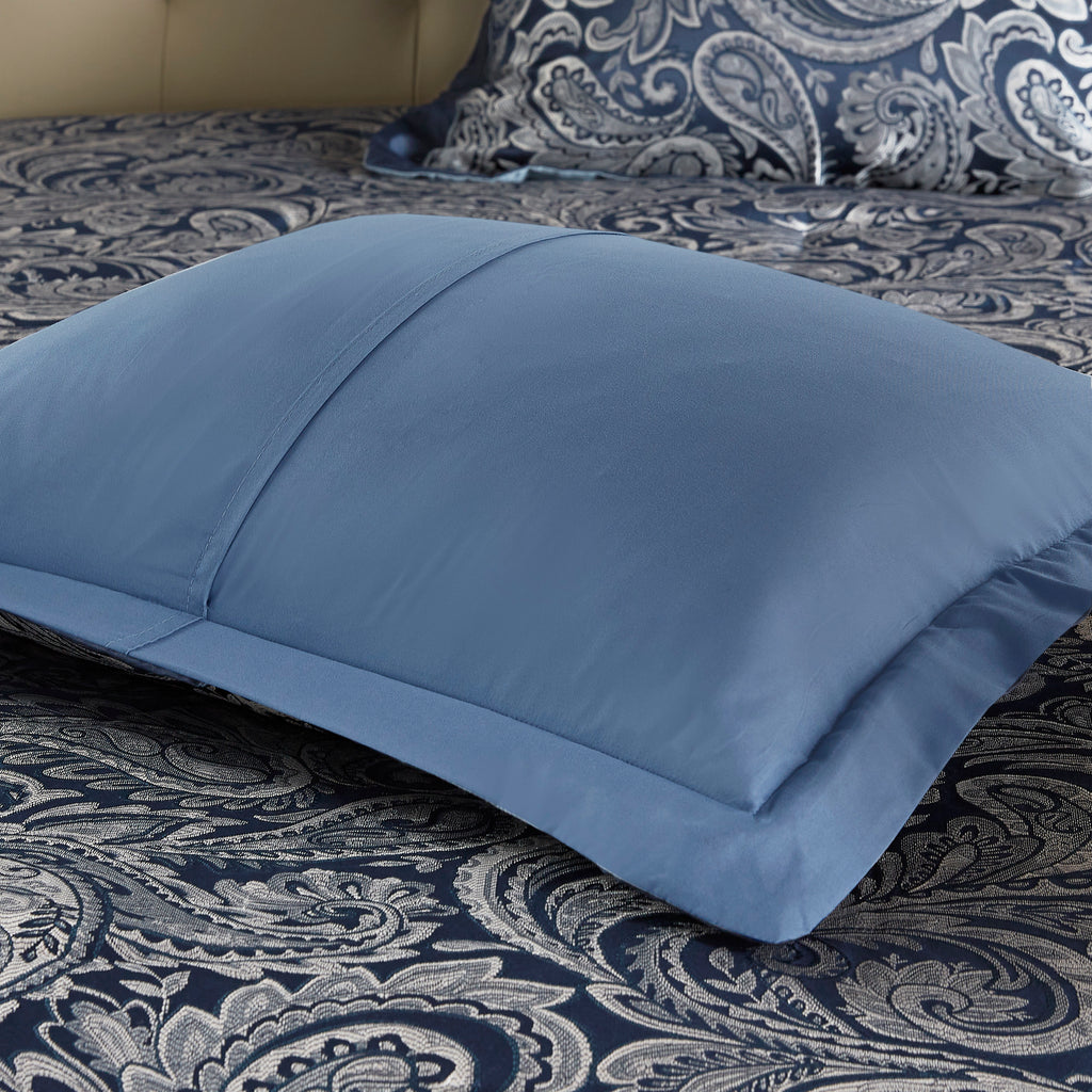 Navy jacquard cotton 12-piece Atelier Comforter Set by Anthony & Home, with decorative pillows and matching bed linens.
