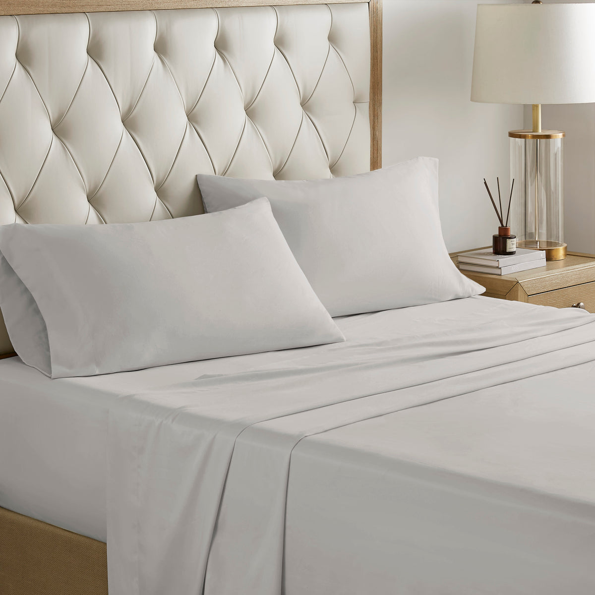 Navy jacquard cotton 12-piece Atelier Comforter Set by Anthony & Home with matching pillow shams and decorative bedding.