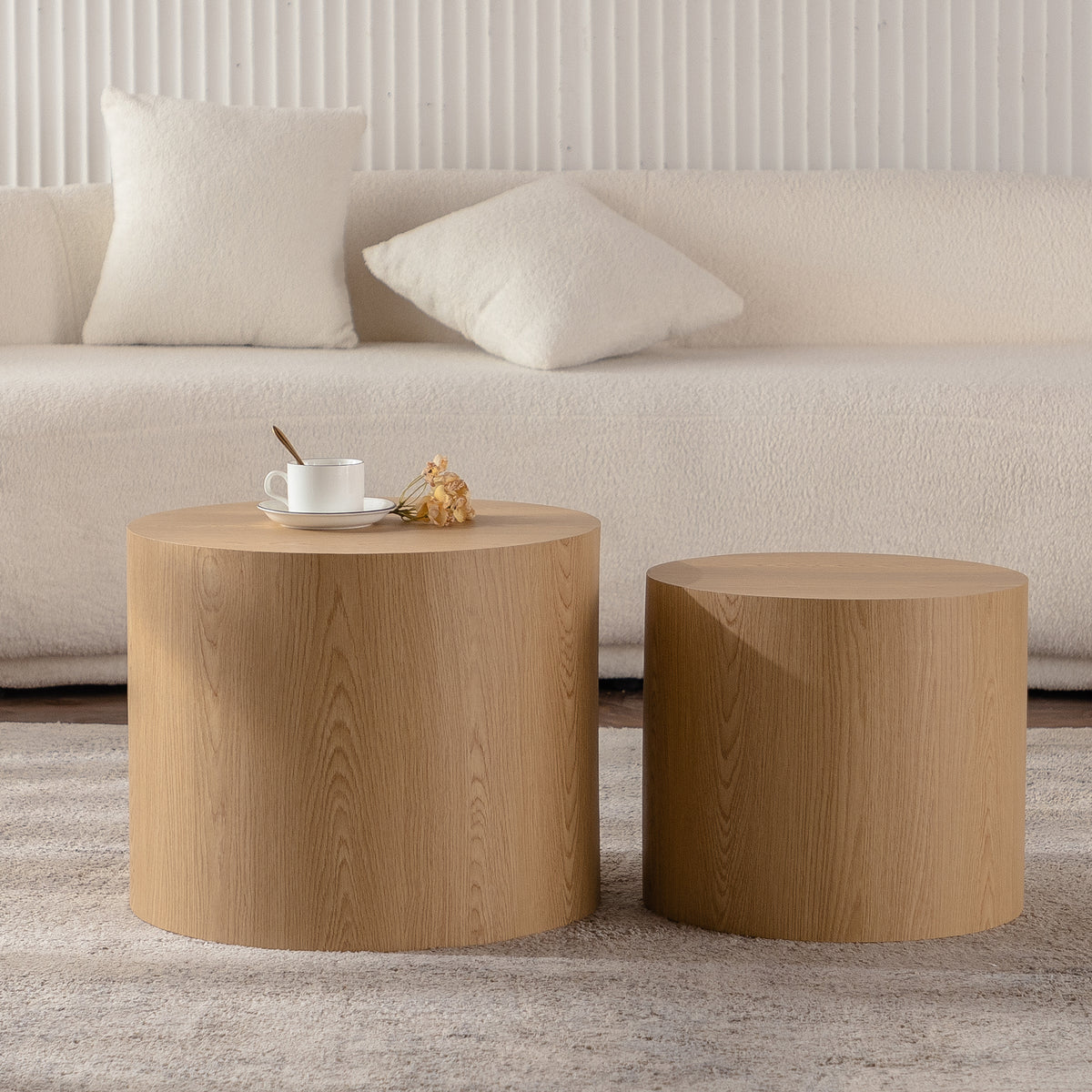 Set of nesting round coffee tables by Anthony & Home featuring sleek wooden tops and modern design.