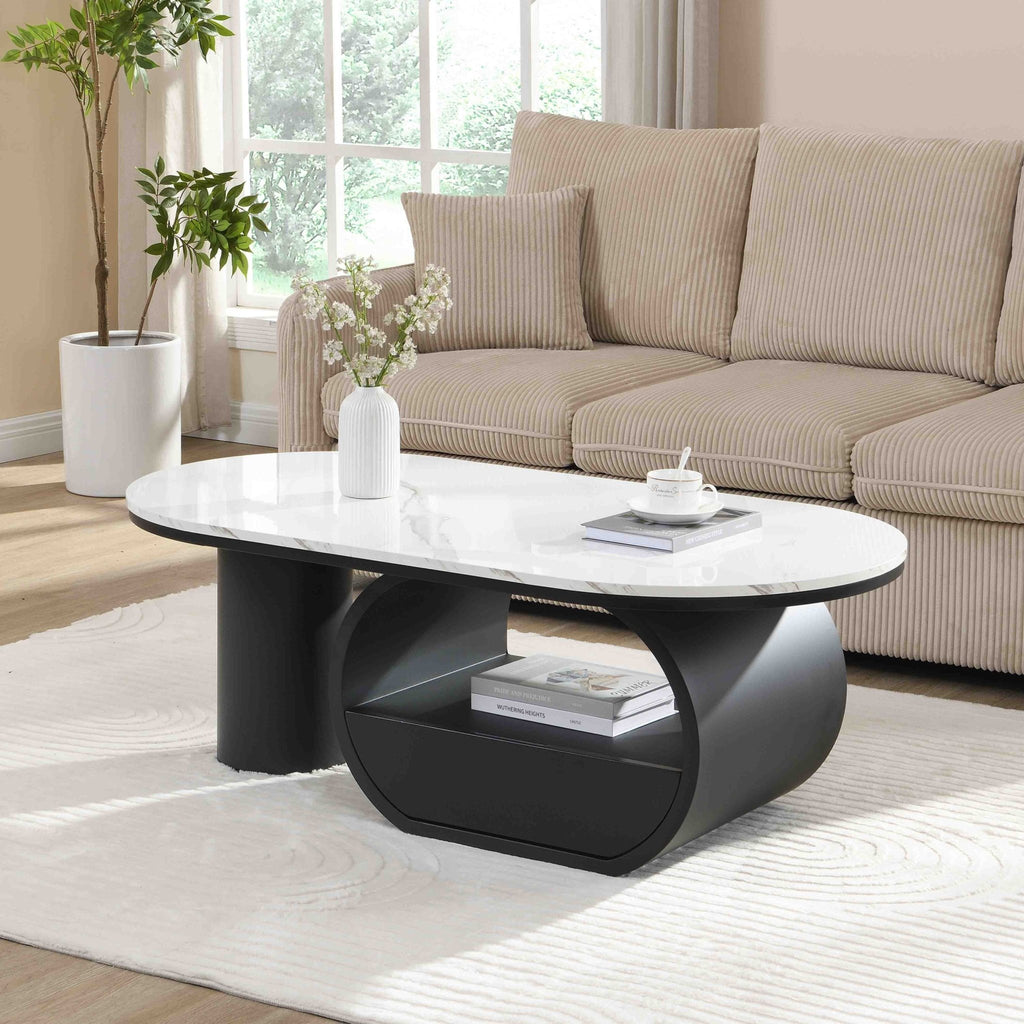 Oval coffee table with faux marble top and black metal frame, modern studio style from Anthony & Home.