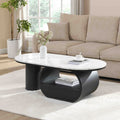 Oval coffee table with faux marble top and black metal frame, modern studio style from Anthony & Home.