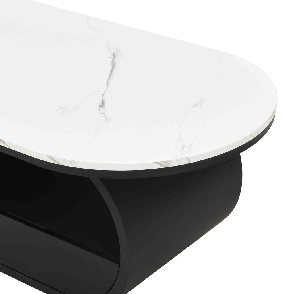 Oval coffee table with faux marble top and black metal frame, styled in a modern studio setting by Anthony & Home