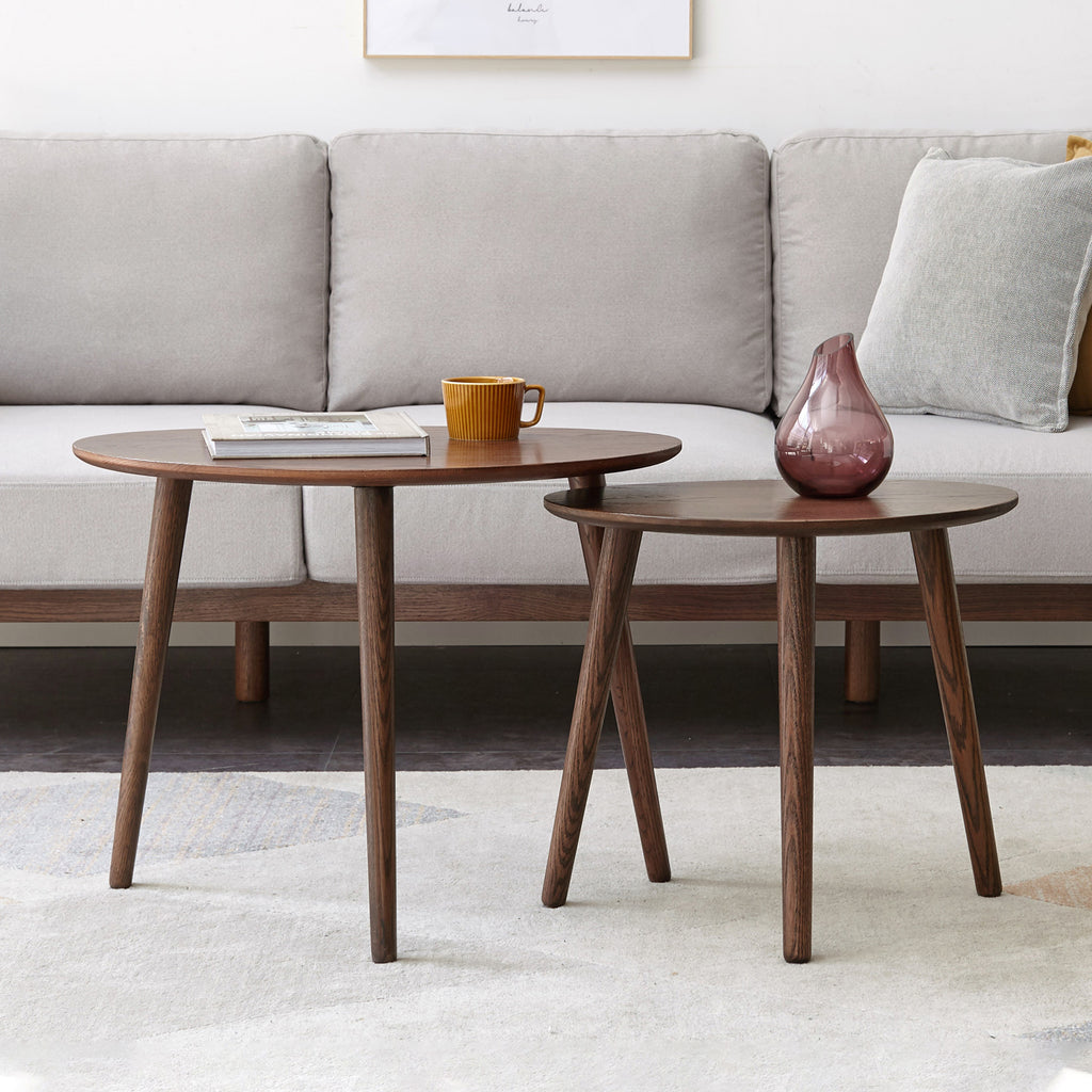 Pebble-shaped coffee table with walnut finish, mid-century modern style, limited edition by Anthony & Home, showing smooth rounded surface.