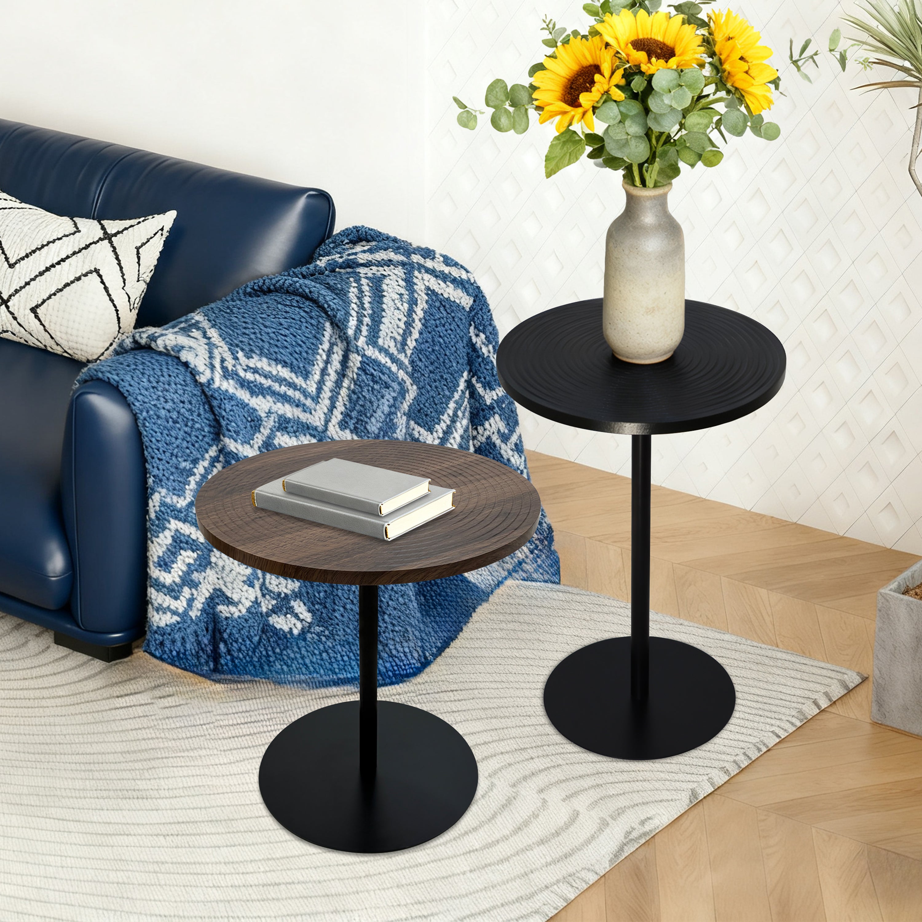 Set of 2 walnut round side tables with black metal pedestal bases featuring concentric design by Anthony & Home.
