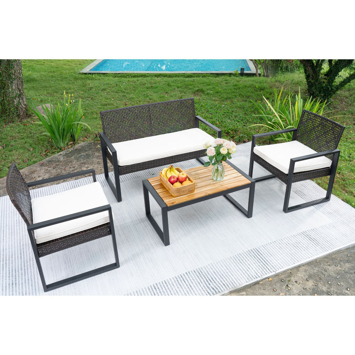 Outdoor patio set by Anthony & Home featuring acacia wood table and chairs with beige cushions, ideal for outdoor dining and relaxation.