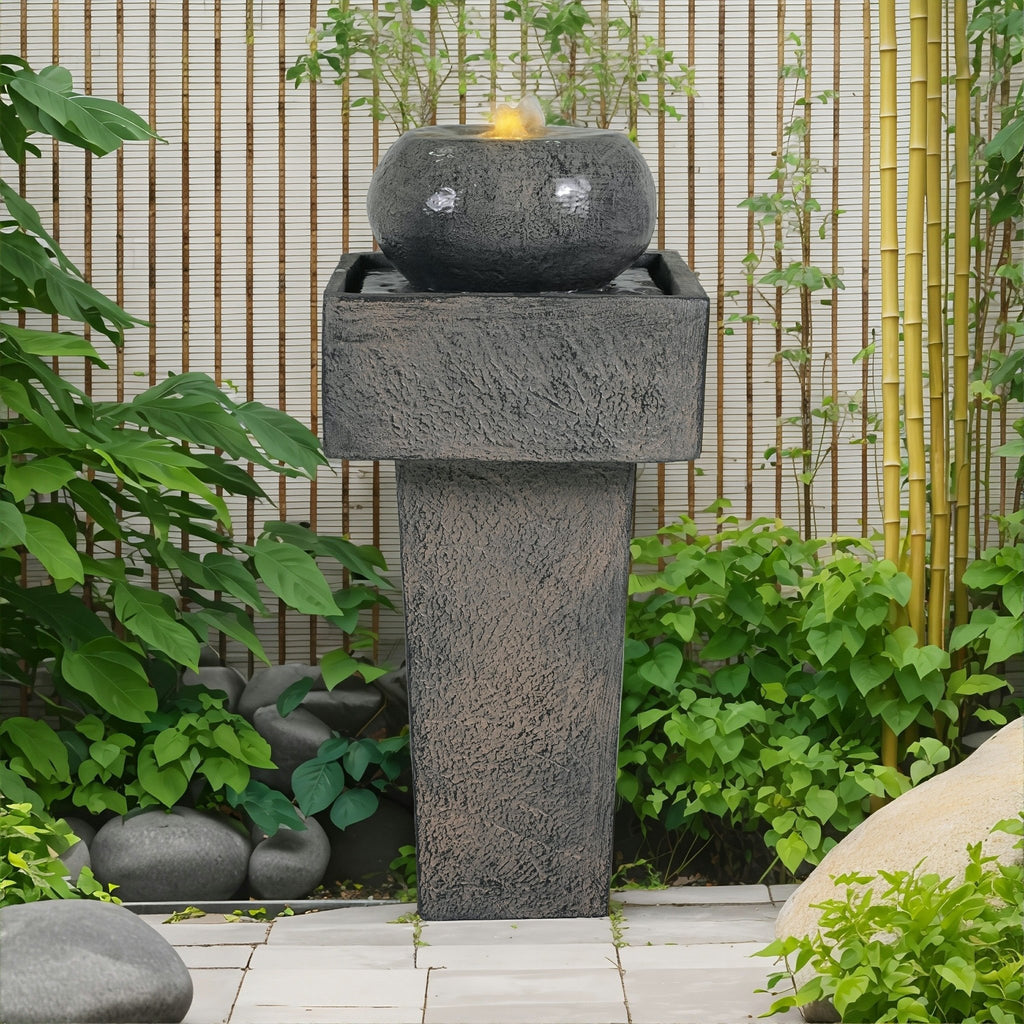 Anthony & Home Signature Concrete Column Fountain with integrated lighting, featuring a tall, textured concrete design and illuminated water feature.