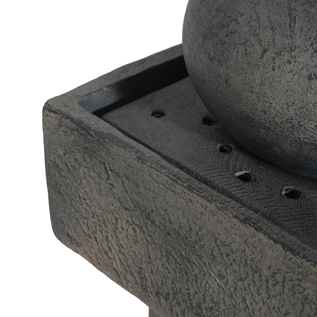 Anthony & Home Signature Concrete Column Fountain with integrated lighting, showcasing a stylish outdoor water feature in a garden setting.