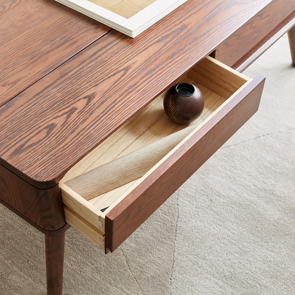 Solid oak center lift-top table from Anthony & Home's Atelier Collection with hidden storage shelf, showcasing a timeless design.