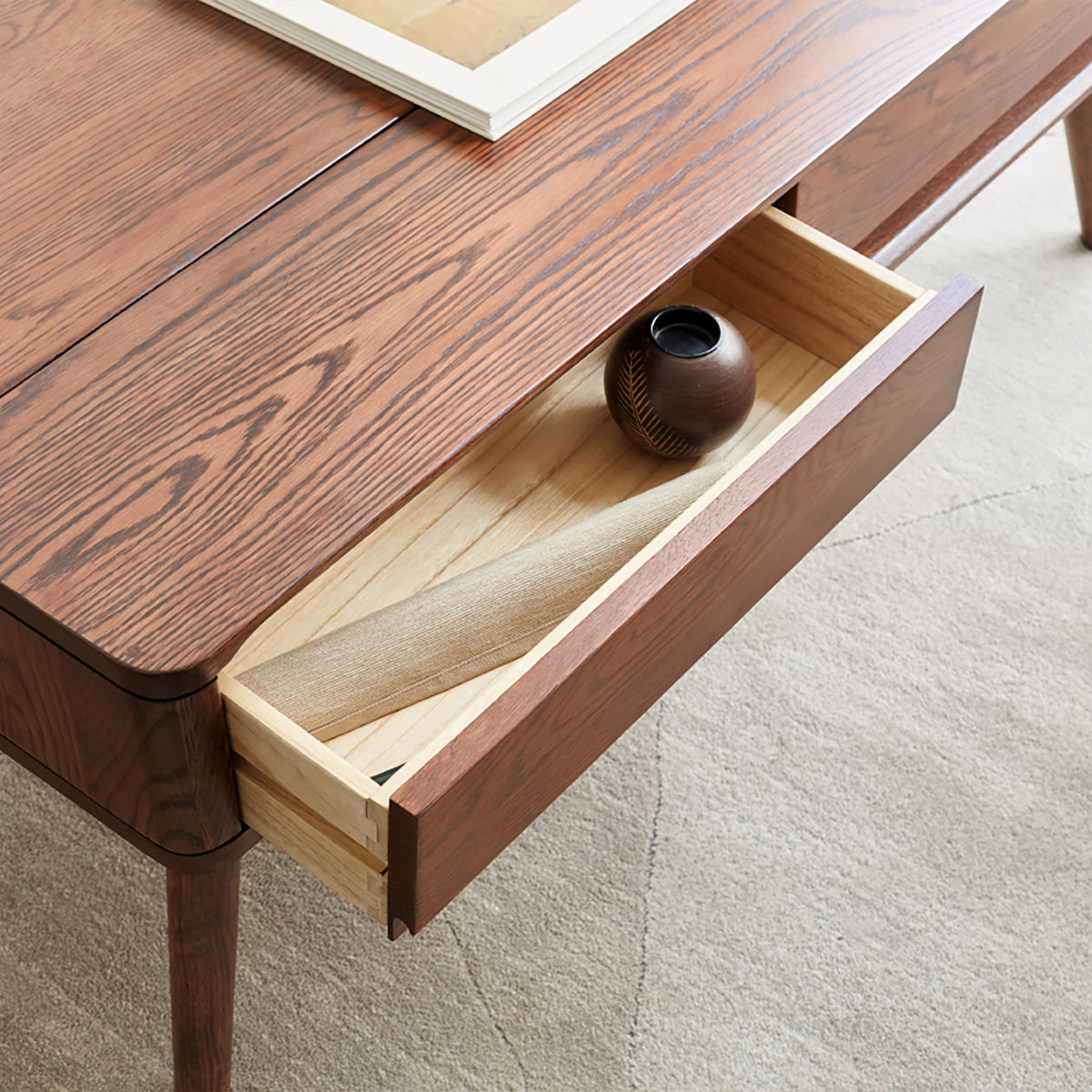 Solid oak center lift-top table from Anthony & Home's Atelier Collection with hidden storage shelf, showcasing a timeless design.