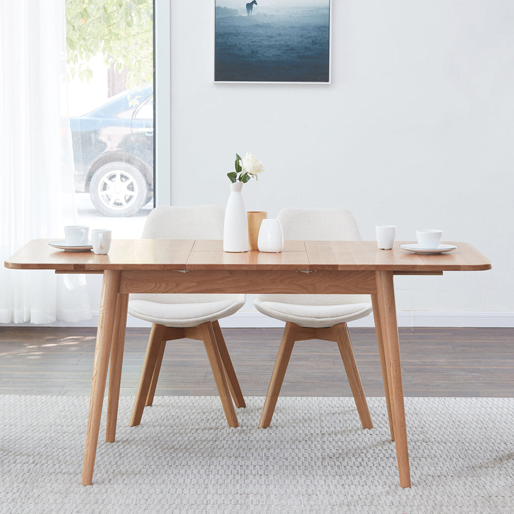 Solid oak extendable dining table by Anthony & Home, showcasing its natural wood finish and sleek modern design.