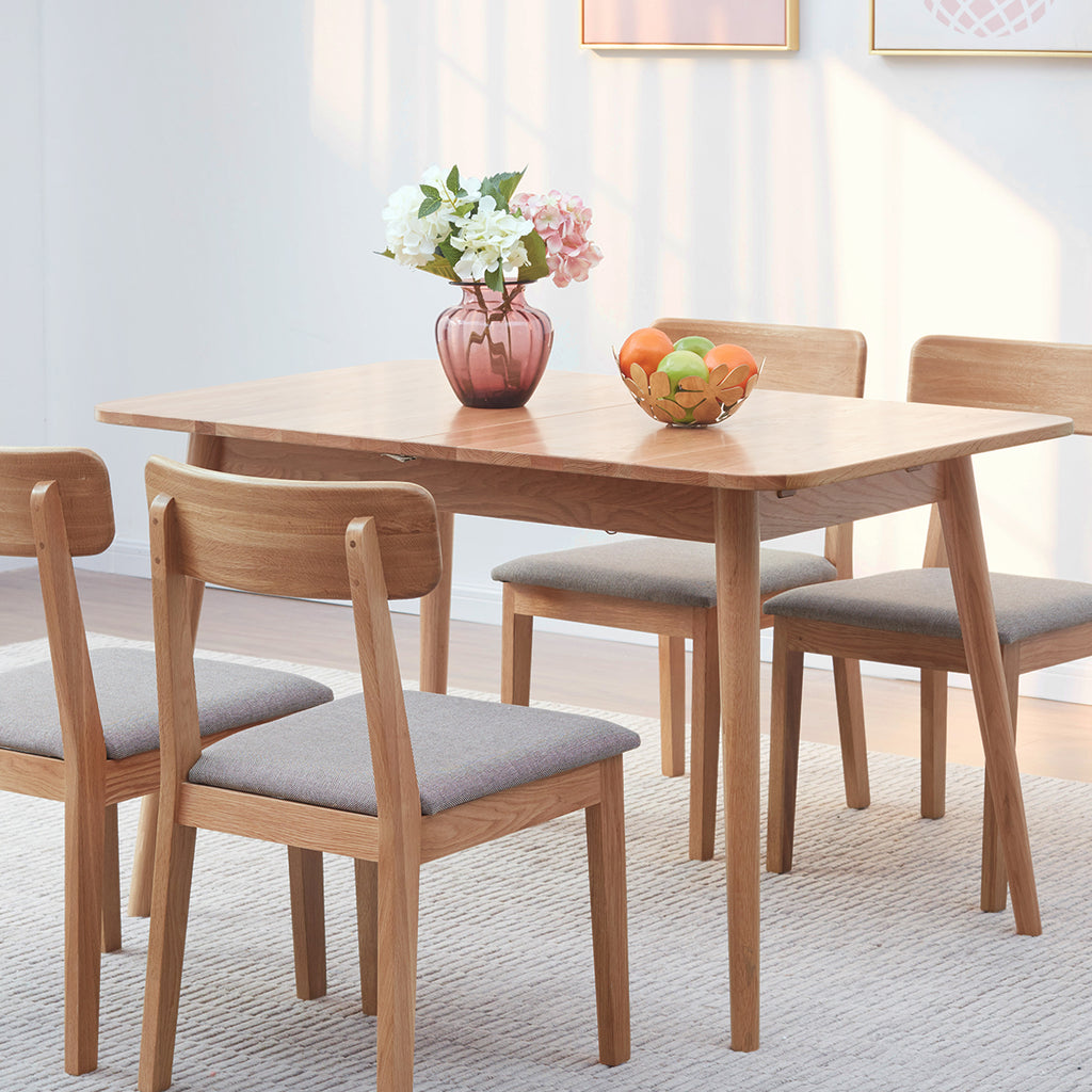 Extendable solid oak dining table by Anthony & Home, showcasing a sleek, natural wood finish and adjustable length for versatile dining space.