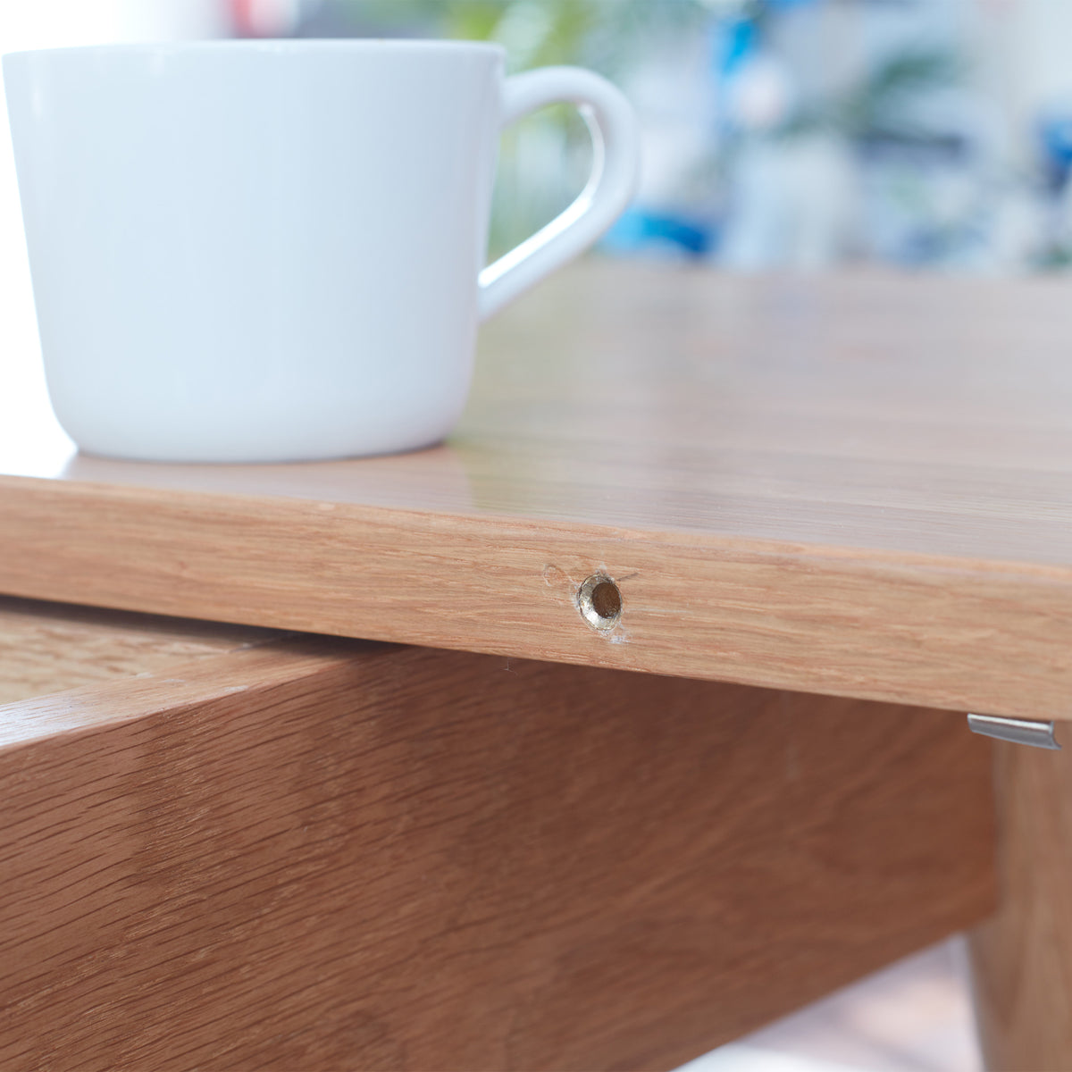 Solid oak extendable dining table by Anthony & Home, shown in a modern dining room setting with extended leaves.