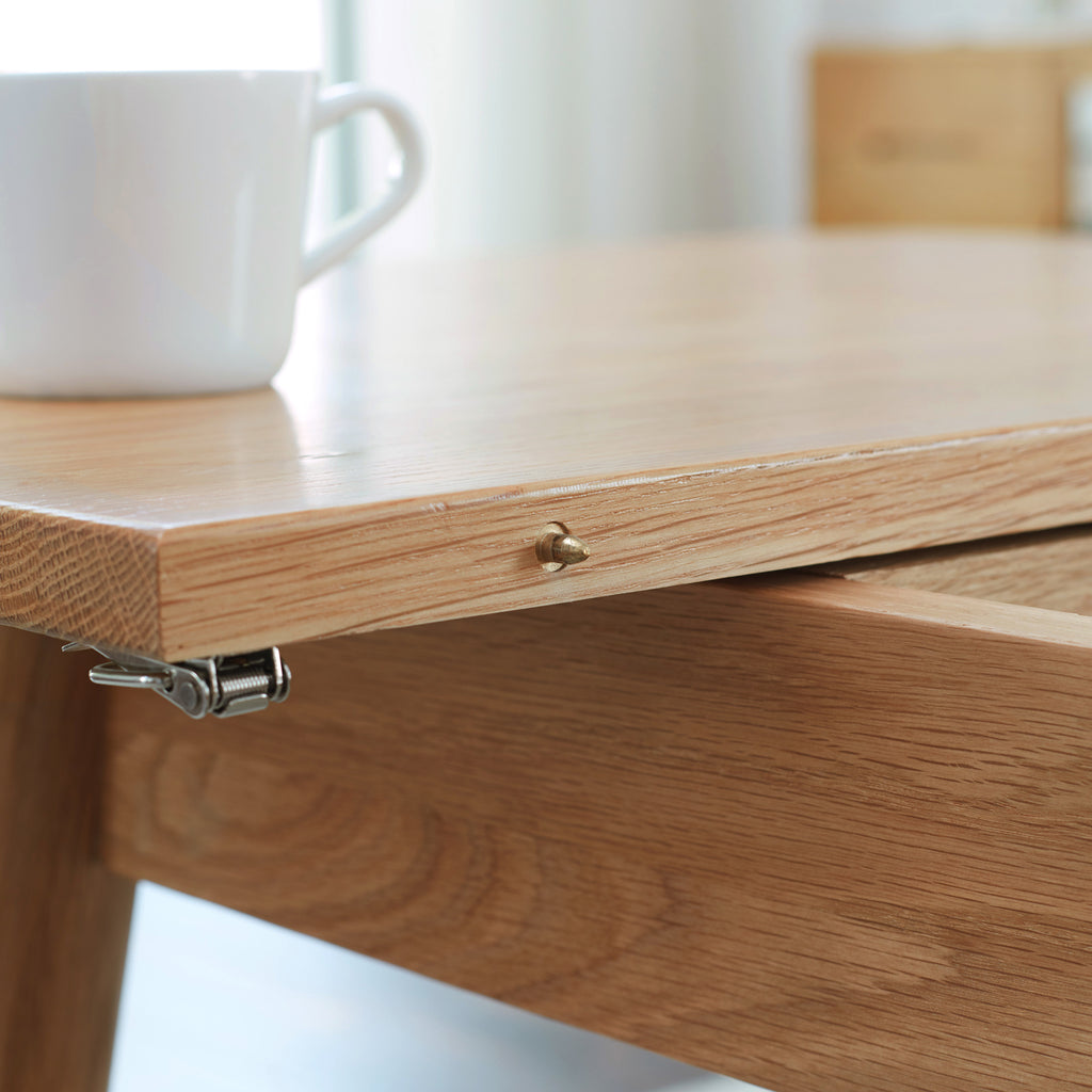 Solid oak extendable dining table by Anthony & Home with a natural wood finish and adjustable length for versatile dining space.