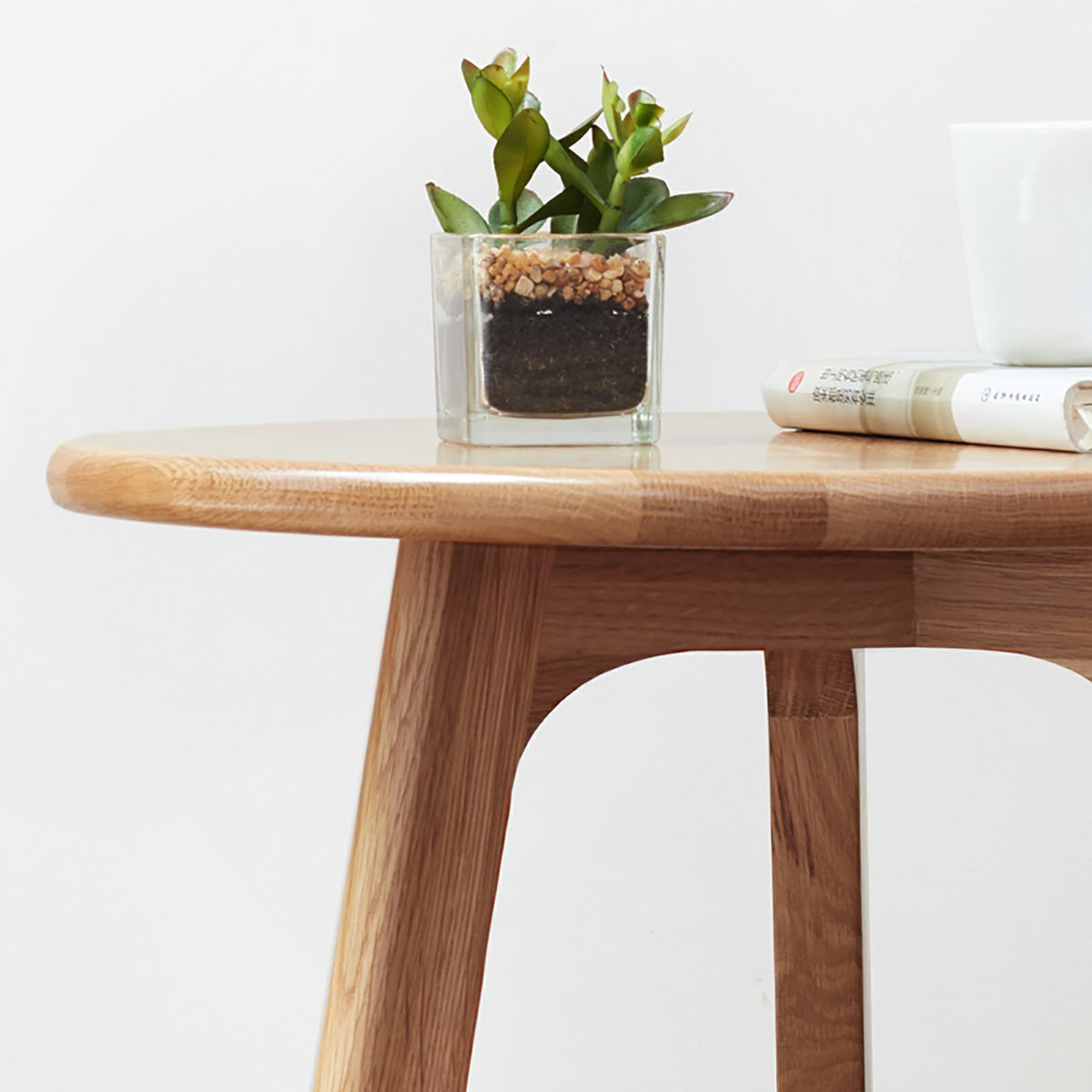 Solid oak round end table from Anthony & Home Signature Collection, featuring a smooth surface and sturdy wooden construction.