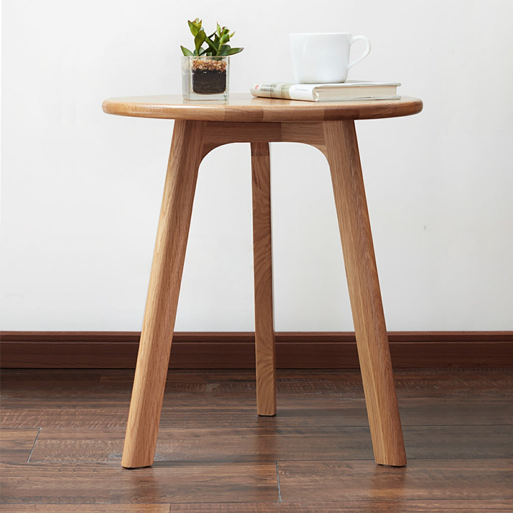 Solid oak round end table from Anthony & Home Signature Collection, featuring a smooth wooden surface and sturdy legs.