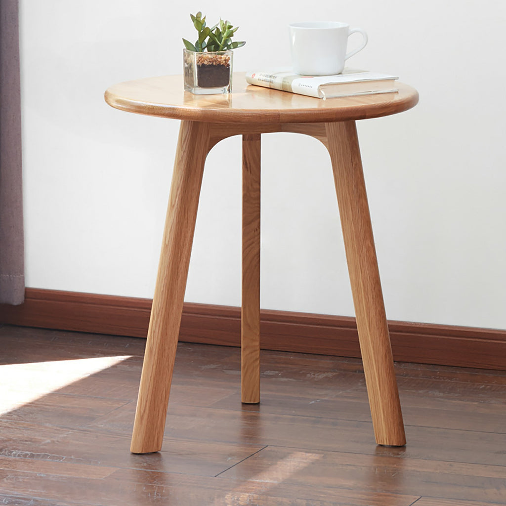 Solid oak round end table from Anthony & Home's Signature Collection, featuring a smooth tabletop and sturdy wooden legs.