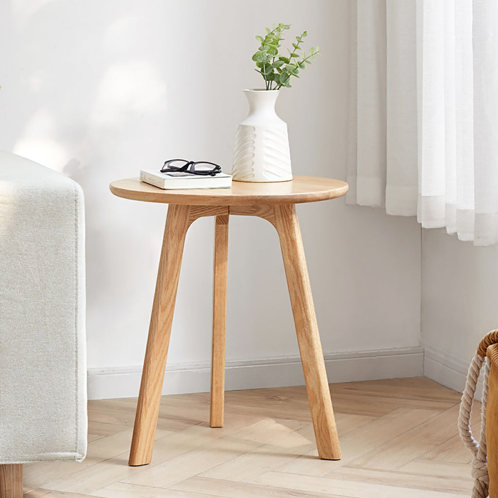 Solid oak round end table from Anthony & Home Signature Collection, featuring a smooth surface and natural wood grain.