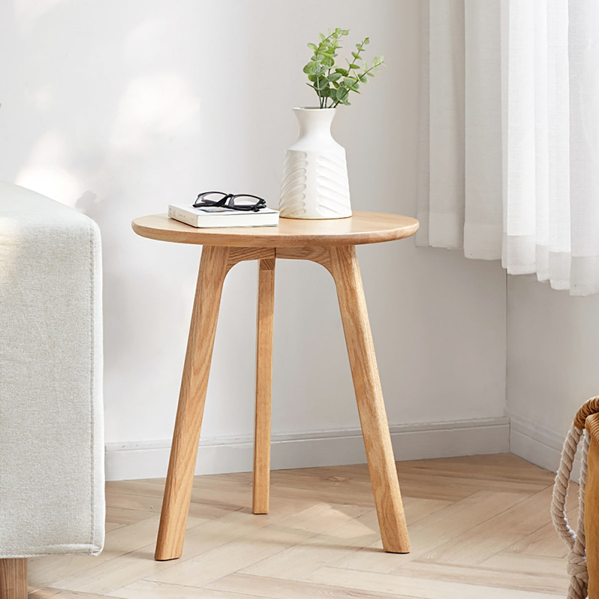 Solid oak round end table from Anthony & Home Signature Collection, featuring a smooth surface and natural wood grain.
