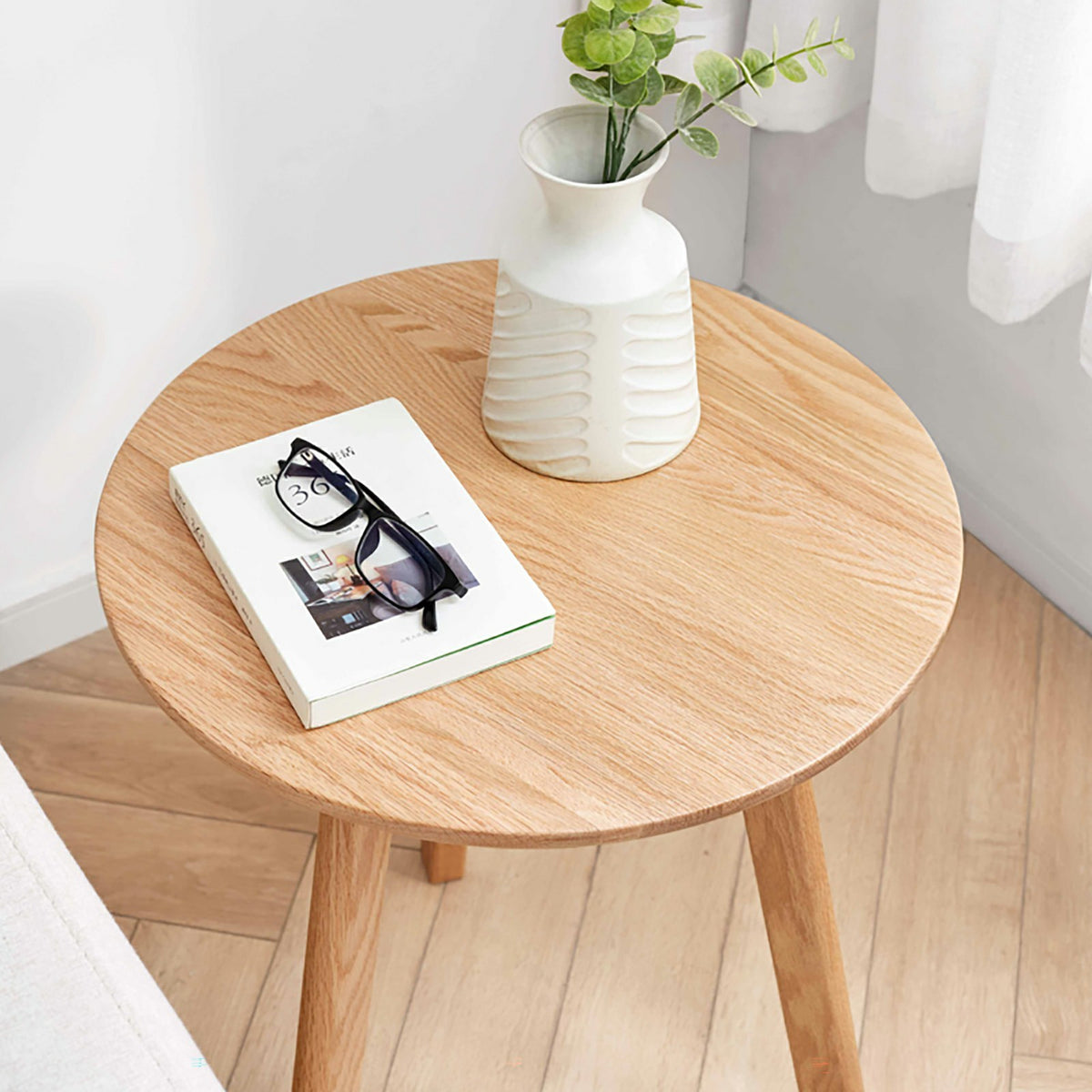 Solid oak round end table from Anthony & Home's Signature Collection, featuring a smooth wood finish and sturdy design.
