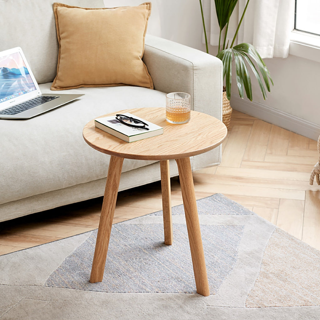 Solid oak round end table from Anthony & Home Signature Collection, featuring a smooth wood finish and sturdy design.