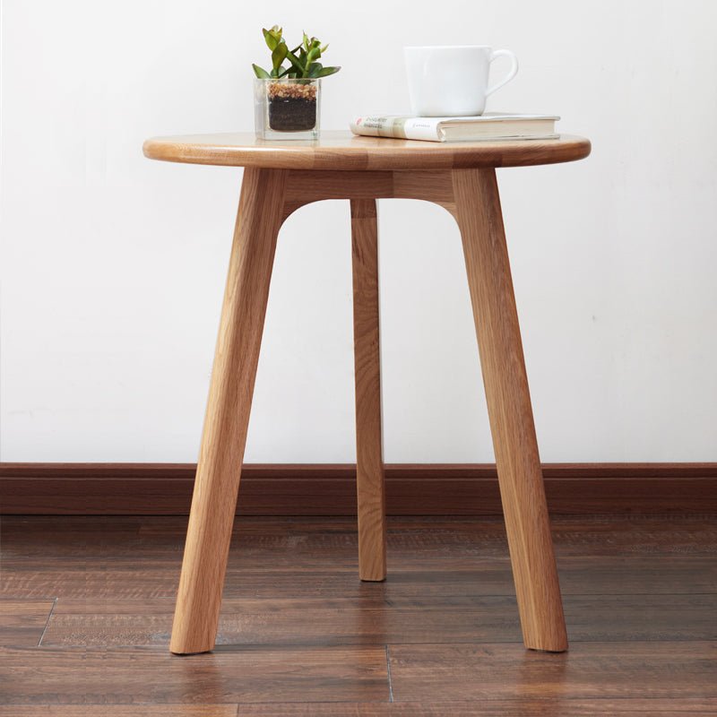 Solid oak round end table from Anthony & Home's Signature Collection, featuring a smooth wooden surface and sturdy legs.