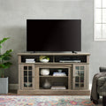 Gray wash finish television media console by Anthony & Home with storage compartments and sleek modern design.