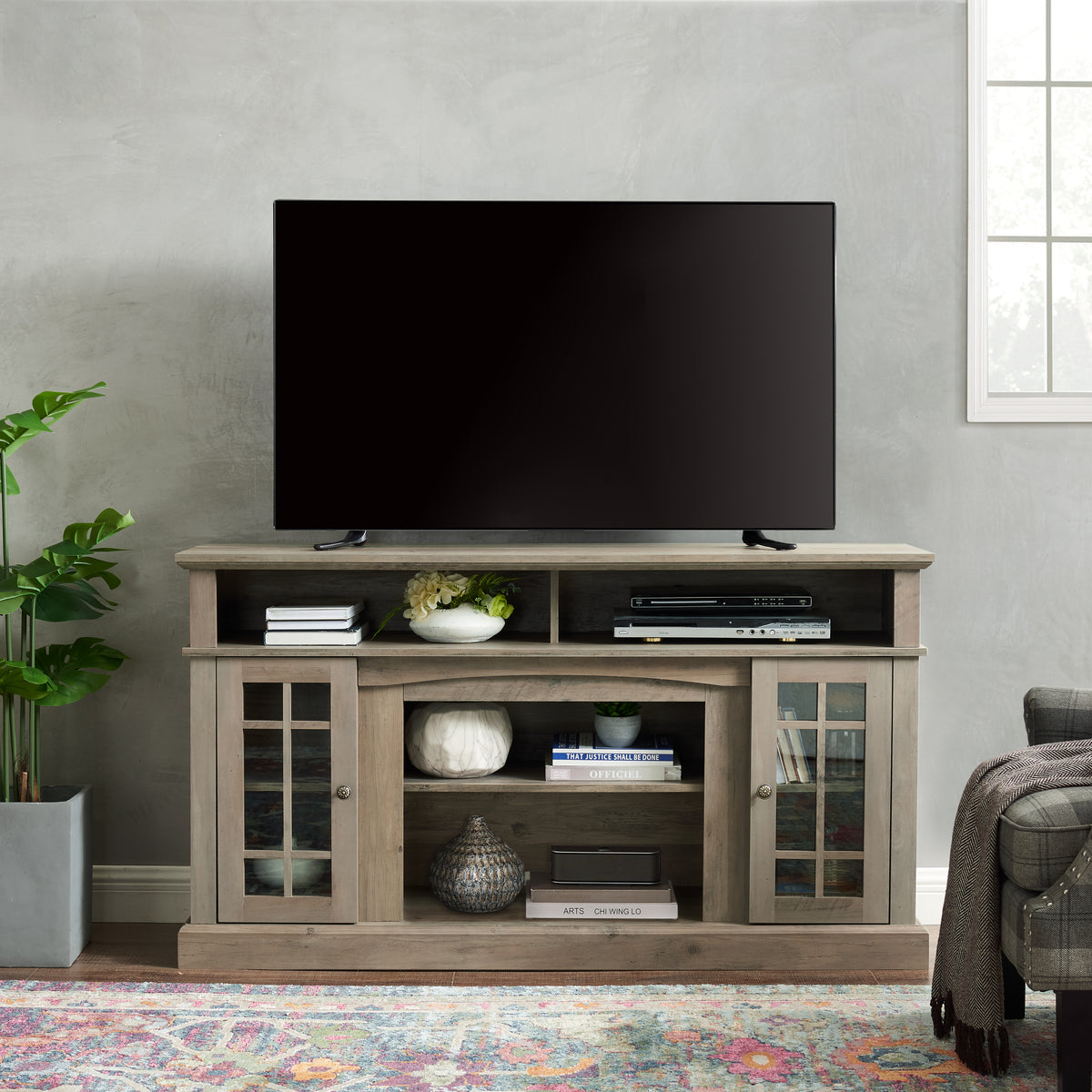 Gray wash finish television media console by Anthony & Home with storage compartments and sleek modern design.