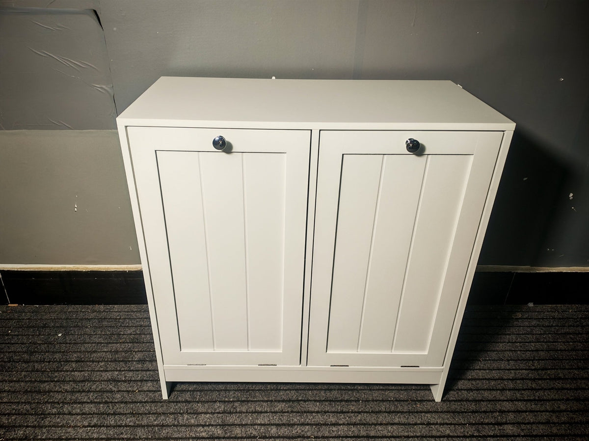 White lacquered limited edition tilted laundry hamper by Anthony & Home, showcasing a sleek, modern design with a tilted shape.