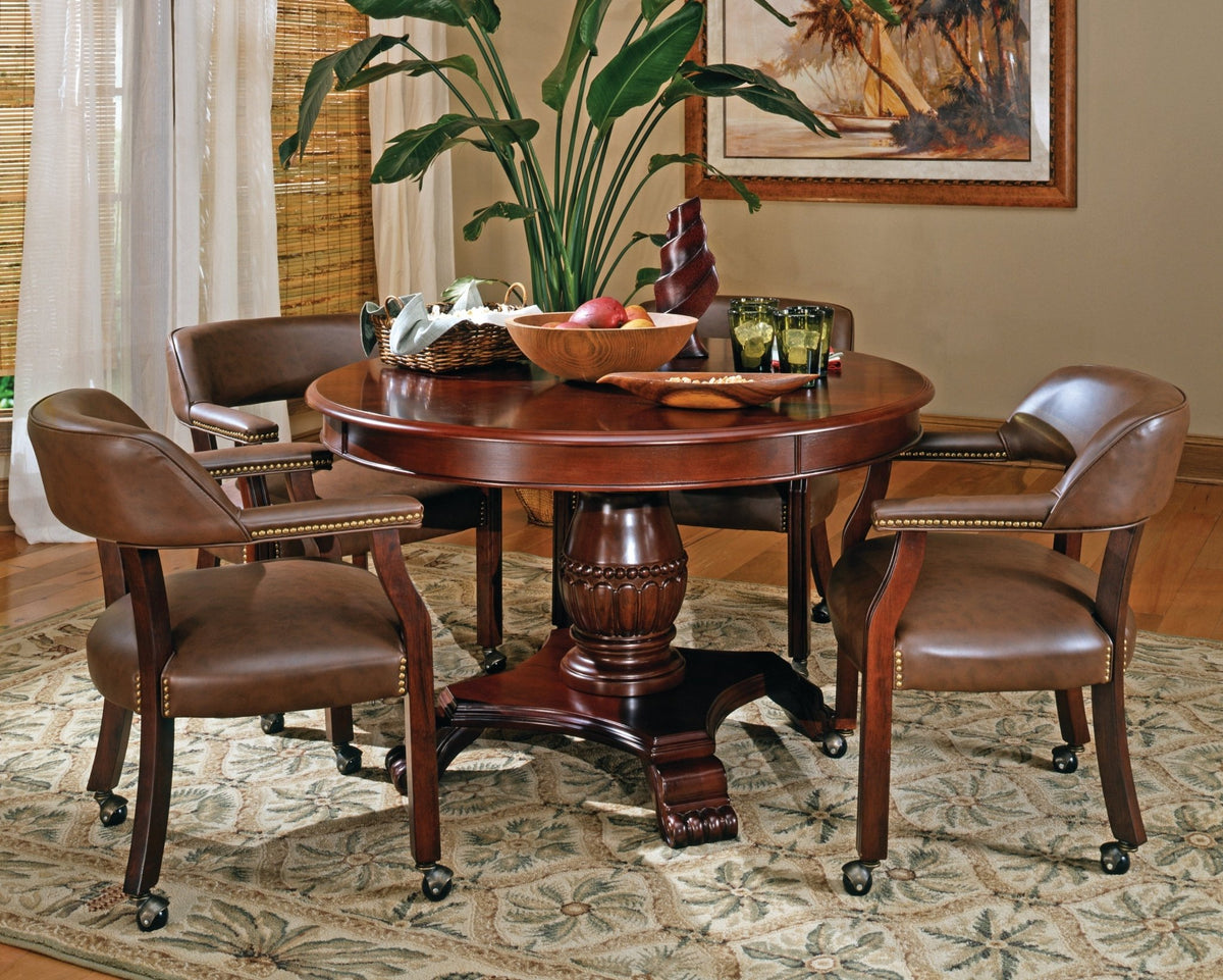 Dark brown fabric traditional armchair with casters and beaded pedestal from Anthony & Home's Atelier Collection.