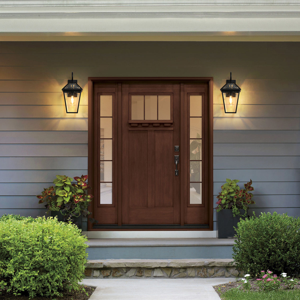 Two-pack outdoor wall lanterns in matte black die-cast with clear glass panels, suitable for exterior lighting.
