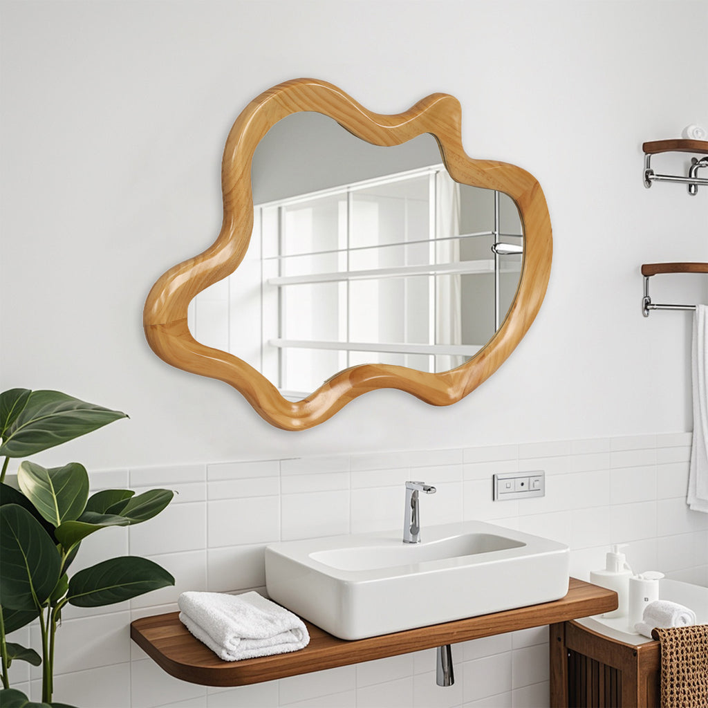 Wall mirror with natural wood frame and irregular silhouette by Anthony & Home, showcasing its unique organic shape and wood texture.