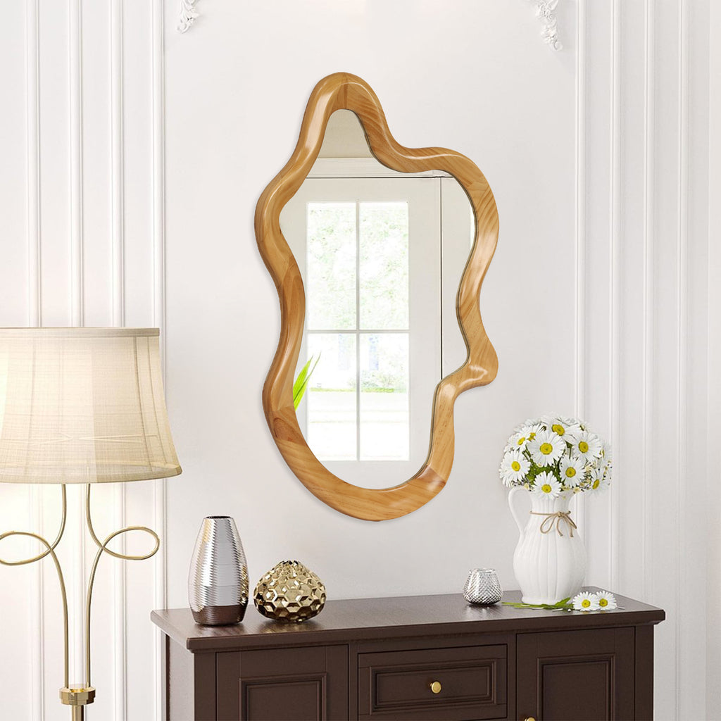 Wall mirror with natural wood frame and irregular silhouette by Anthony & Home, showcasing a unique, organic shape.