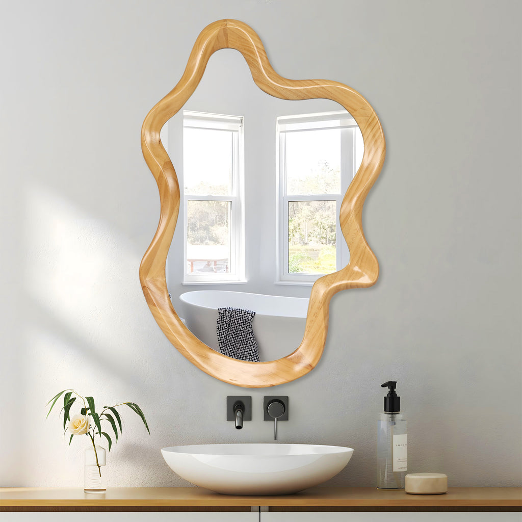 Wall mirror with natural wood frame and irregular silhouette, by Anthony & Home, showing its unique organic shape.